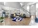 Open-concept living room with hardwood floors, two sofas, fireplace, and stairs at 3889 Elm Trace Dr, Loganville, GA 30052