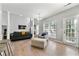 Spacious living room with hardwood floors, fireplace, and ample natural light at 3889 Elm Trace Dr, Loganville, GA 30052