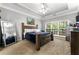 Spacious main bedroom with tray ceilings, a large window, and stylish furnishings at 3889 Elm Trace Dr, Loganville, GA 30052