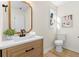 This bathroom features a light wood vanity with modern fixtures, white quartz countertop and wood look flooring at 9347 Haley Ct, Jonesboro, GA 30238