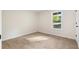 This bedroom features a neutral wall color, plush carpet, and a large window at 9347 Haley Ct, Jonesboro, GA 30238