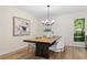 Dining room with a unique modern light fixture and a rustic wooden table with seating for four at 9347 Haley Ct, Jonesboro, GA 30238