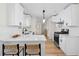 Stylish kitchen with white cabinets, stainless steel appliances, and a breakfast bar at 9347 Haley Ct, Jonesboro, GA 30238