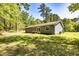 Exterior view of the backyard with lush greenery, trees, and the rear of the home at 108 Dove, Peachtree City, GA 30269