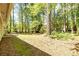 The backyard features a lush lawn surrounded by mature trees and a patio area at 108 Dove, Peachtree City, GA 30269