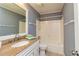 Well-lit bathroom featuring a granite countertop vanity and a shower-tub combo at 108 Dove, Peachtree City, GA 30269