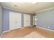 A bedroom featuring double closets, neutral carpet and fresh, blue-grey paint at 108 Dove, Peachtree City, GA 30269