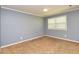 Cozy bedroom with neutral carpet, blue-grey walls, and a window for natural light at 108 Dove, Peachtree City, GA 30269
