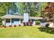 Charming single story home with blue siding, a well-manicured lawn, and mature landscaping at 108 Dove, Peachtree City, GA 30269