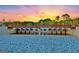 Picturesque view of Lake Peachtree dam at sunset, framed by blue rocks and lush greenery at 108 Dove, Peachtree City, GA 30269