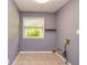 Utility room with tile flooring, neutral paint, and a large window at 108 Dove, Peachtree City, GA 30269