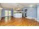 Open-concept living space with hardwood floors, French doors to backyard and convenient kitchen access at 108 Dove, Peachtree City, GA 30269