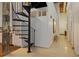 Hallway featuring a black spiral staircase, white walls, and an open floor plan leading to other living spaces at 170 Boulevard Se # 115E, Atlanta, GA 30312