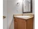 Bathroom vanity featuring granite countertops and a decorative mirror, adding a touch of elegance at 3655 Habersham Ne Rd # B-254, Atlanta, GA 30305