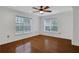 Bedroom featuring hardwood floors, ceiling fan, and two large windows for natural light at 3655 Habersham Ne Rd # B-254, Atlanta, GA 30305
