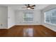 Bedroom with hardwood floors, ceiling fan, and large window allowing natural light at 3655 Habersham Ne Rd # B-254, Atlanta, GA 30305