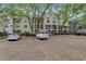 Exterior shot showcasing a multi-level home with parking, landscaping and many lovely trees at 3655 Habersham Ne Rd # B-254, Atlanta, GA 30305