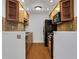 Galley kitchen featuring wooden cabinets, stainless steel appliances, and a light brown tiled backsplash at 3655 Habersham Ne Rd # B-254, Atlanta, GA 30305