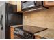 Close up shot of the stainless steel oven and black refrigerator in this home's kitchen at 3655 Habersham Ne Rd # B-254, Atlanta, GA 30305