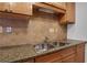 Stainless steel sink and faucet with granite countertops and natural wood cabinets at 3655 Habersham Ne Rd # B-254, Atlanta, GA 30305