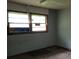 Empty room with dirty floors and boarded windows at 4758 Highway 81, Mcdonough, GA 30252