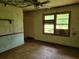 Bedroom with wood floors and vintage wallpaper at 4758 Highway 81, Mcdonough, GA 30252