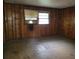 Empty room with wood walls and dirty floors at 4758 Highway 81, Mcdonough, GA 30252