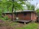 Side view of a brick house with a small deck at 4758 Highway 81, Mcdonough, GA 30252
