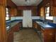 Outdated kitchen with blue countertop and wood cabinets at 4758 Highway 81, Mcdonough, GA 30252
