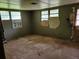 Bare room with dirty floors and boarded windows at 4758 Highway 81, Mcdonough, GA 30252