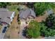 Aerial view of a two-story house with lush trees, landscaped lawn, and a driveway at 4766 Cedar Wood Sw Dr, Lilburn, GA 30047