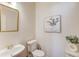 Half bathroom featuring a white sink, toilet, and neutral wall paint at 4766 Cedar Wood Sw Dr, Lilburn, GA 30047
