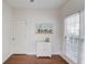 Bedroom with hardwood floors, blind-covered windows, and white storage cabinet at 4766 Cedar Wood Sw Dr, Lilburn, GA 30047
