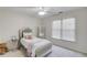 Cozy bedroom featuring a plush bed, mirror, and a sunlit window at 4766 Cedar Wood Sw Dr, Lilburn, GA 30047