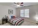 Bright bedroom with a striped bed, window and nightstand at 4766 Cedar Wood Sw Dr, Lilburn, GA 30047