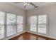 Empty bedroom showing natural light, hardwood floors, and a ceiling fan at 4766 Cedar Wood Sw Dr, Lilburn, GA 30047