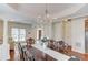 Open dining room with hardwood floors, elegant chandelier, and seamless flow into the living room at 4766 Cedar Wood Sw Dr, Lilburn, GA 30047