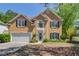 Charming two-story home with a well-manicured lawn and a two-car garage at 4766 Cedar Wood Sw Dr, Lilburn, GA 30047