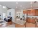 Open kitchen view to living area with stainless appliances and wooden cabinetry at 4766 Cedar Wood Sw Dr, Lilburn, GA 30047