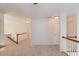 Second floor landing features neutral carpet, white trim, wood railings, and multiple entry doors at 4766 Cedar Wood Sw Dr, Lilburn, GA 30047