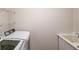 Laundry room features a modern washing machine and dryer with a sink at 4766 Cedar Wood Sw Dr, Lilburn, GA 30047