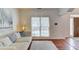 Comfortable living room with hardwood floors, a sofa and large windows for light at 4766 Cedar Wood Sw Dr, Lilburn, GA 30047