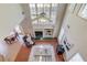 Second-story view of the living room, highlighting the fireplace and natural light at 4766 Cedar Wood Sw Dr, Lilburn, GA 30047