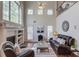 Spacious living room with a fireplace, large windows, and a vaulted ceiling at 4766 Cedar Wood Sw Dr, Lilburn, GA 30047