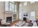 Sun-filled living room with fireplace, hardwood floors, and two-story windows at 4766 Cedar Wood Sw Dr, Lilburn, GA 30047