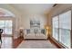 Cozy living room featuring hardwood floors, neutral decor, and large windows at 4766 Cedar Wood Sw Dr, Lilburn, GA 30047