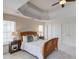 Main bedroom featuring a bed with nightstands, neutral paint, and an alcove ceiling at 4766 Cedar Wood Sw Dr, Lilburn, GA 30047