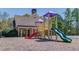 Community playground area with slides and climbing structures, perfect for families at 4766 Cedar Wood Sw Dr, Lilburn, GA 30047