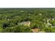 A serene aerial view showcasing the home nestled among mature trees in a lush landscape at 492 Mary Hill Ln, Douglasville, GA 30134