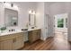 Bathroom with double sinks, quartz countertops, modern fixtures, and hardwood floors at 492 Mary Hill Ln, Douglasville, GA 30134